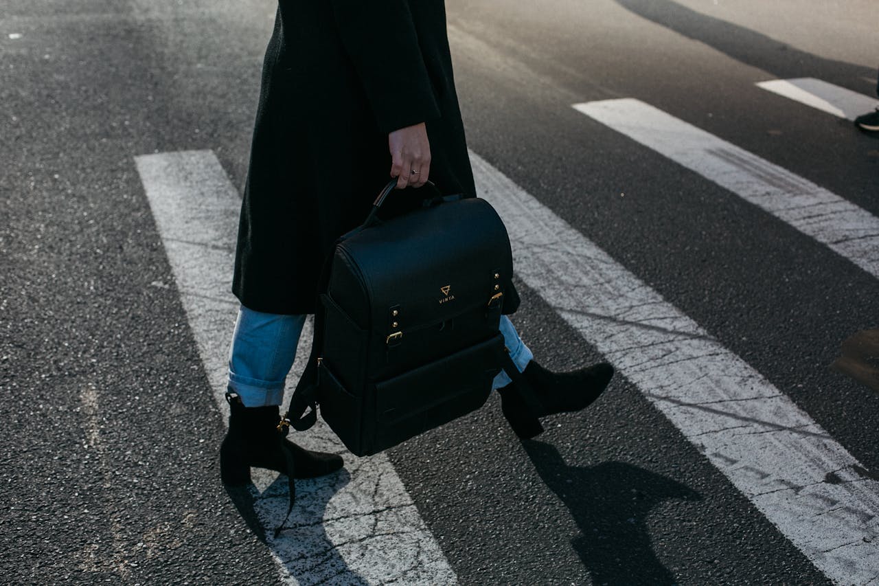 The Art of Drawing Readers In: Your attractive post title goes here A person crosses a zebra crosswalk holding a stylish black bag in New York City.